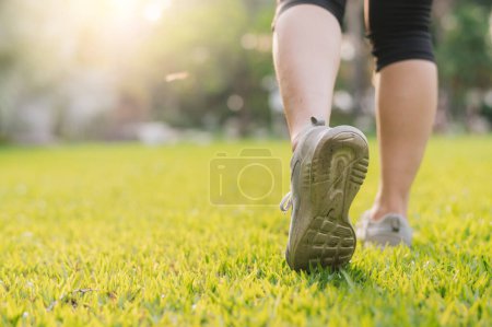 Photo for Jogger woman. close up person training sport runner young female shoe on grasses in public park. fitness foot and leg exercise athlete. marathon in nature. active healthy lifestyle workout concept. - Royalty Free Image