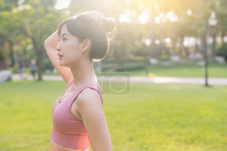 Photo for Experience the joy of wellness living as a happy, beautiful Asian woman 30s in a park at sunset. - Royalty Free Image