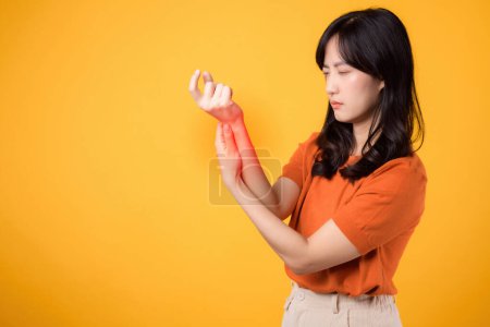 Photo for Portrait of young lady indicating wrist discomfort. Illustrating body ache and joint inflammation due to health issues. - Royalty Free Image