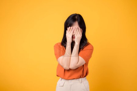 Photo for Sad young woman isolated on yellow background, reflecting inner confusion and anxiety. Expressive portrait of upset emotions - Royalty Free Image