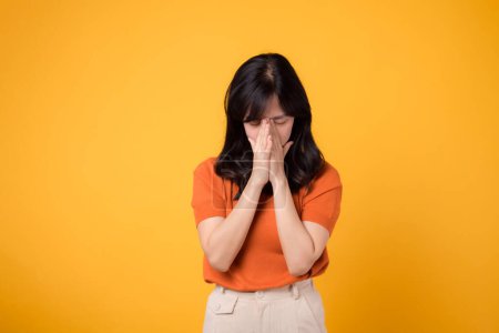 Photo for Unhappy female expressing stress and nervousness. Portrait of worried person isolated in yellow studio background. - Royalty Free Image