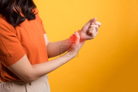 Photo for Studio portrait of woman with wrist pain, portraying arthritis inflammation. Concept of health issue and discomfort. - Royalty Free Image