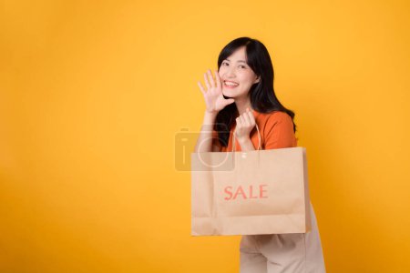 Photo for Celebrate youth and style while shopping with smile. Trendy woman holds bags, presenting discounts and surprises in a retail setting. Join the joyful trend! - Royalty Free Image