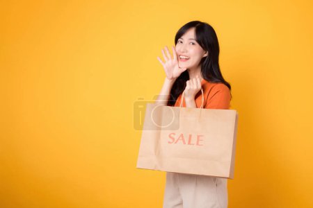 Photo for Embrace retail therapy with a cheerful smile! Trendy young woman celebrates discounts and fashion finds, showcasing her purchases. Join the shopping fun! - Royalty Free Image