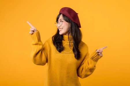 Photo for Fashion forward lady in red beret and eyeglasses, demonstrating a stylish selection, isolated on a cheerful yellow backdrop. - Royalty Free Image