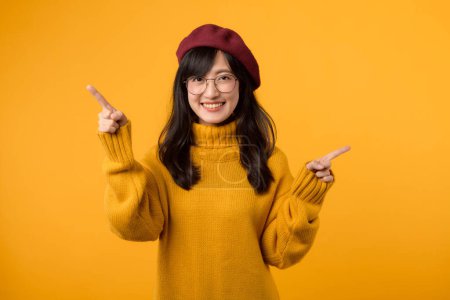 Photo for Fashionable girl in vibrant beret and yellow sweater, promoting clothing choices against a cheerful yellow background. - Royalty Free Image