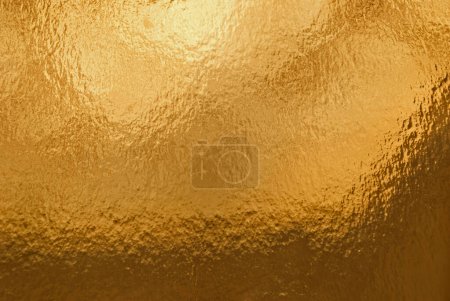 Photo for Gold background, texture. Background of gold foil with light reflections. - Royalty Free Image