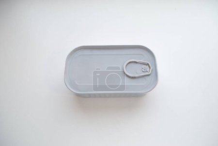 Photo for Rectangular white, aluminum can of flat rectangular shape with a key to open the lid on a white background - Royalty Free Image
