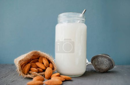 Photo for Vegetarian almond milk. Almonds and almond milk in a bottle. - Royalty Free Image
