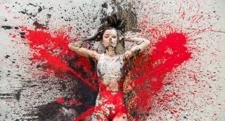 Mujer joven y sexy en ropa interior, ropa deportiva, artísticamente abstracta pintada con pintura blanca, roja y negra, acostada en el colorido piso pintado en el estudio de artistas, espacio para copiar.
