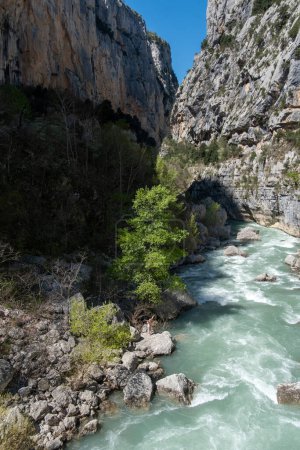 happy naked mature sexy woman feels the joy of life in the Verdon gorge, copy space