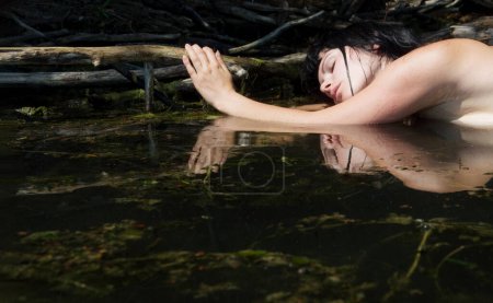 schöne junge sexy nackte Brünette nasse Frau Meerjungfrau Nymphe Porträt Träume sinnlich empfindlich verführerisch im Wasser, See, Teich, klammerte sich an einen Zweig im Wasser liegend, Kopierraum