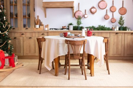 Stylish dining room in rustic style. Cozy kitchen decorated Christmas or new year. horse rocking chair. Mid Century design room. Interior design scandinavian wooden kitchen with round table and chairs
