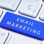 Email Marketing concept. Phrase on blue computer Keyboard Key