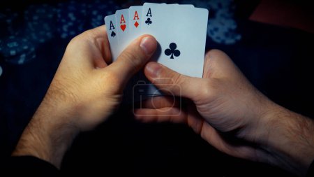 Foto de The player watches art while playing poker. A combination of four aces, four of a kind, winning cards fell out - Imagen libre de derechos