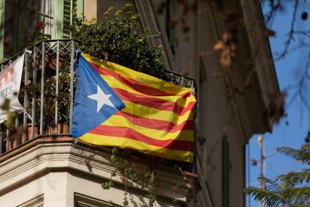 Photo for Barcelona, Spain - 09 Jan, 2022: A flag, estelada, Catalan nationalist independence flag hanging on a balcony in the Gracia district of Barcelona - Royalty Free Image