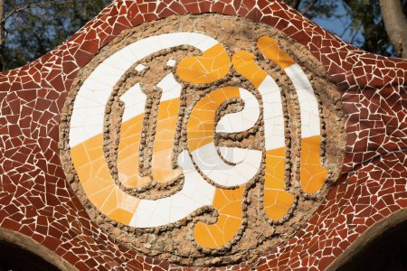 Foto de Barcelona, Spain - 09 Jan, 2022: Entrance sign of the Guell park in Barcelona, made with broken tile pieces - Imagen libre de derechos