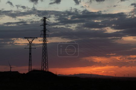 Photo for Infrastructure of high-voltage power towers, which conduct electricity to consumers and industries, generate a large environmental impact - Royalty Free Image