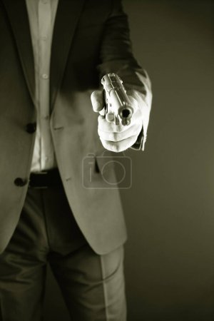 Retro secret agent with pistol revolver gun in hand in vintage crime thriller mockup cover     photo.       