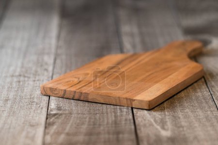Photo for Empty cutting board on weathered wood - Royalty Free Image