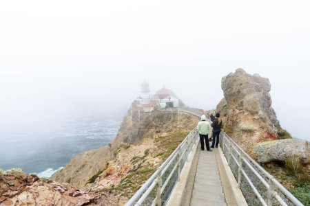Photo for People walking down the stairs to Point Reyes lighthouse with heavy fog. - Royalty Free Image