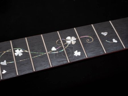 Photo for Close up shot finger board  pearl inlay , heart and flower , acoustic guitar - Royalty Free Image