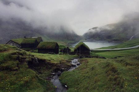 Saksun Village, Streymoy Island, Faroe islands. Old stone houses with a grass (turf) roof. Tourist sightseeing in green valley
