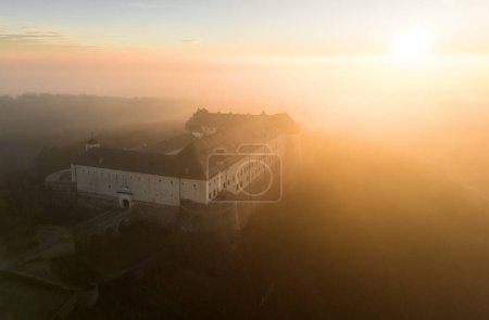 Aerial view of Cerveny Kamen, Red stone castle in the Carpathian mountains in Slovakia dramatic sunrise.