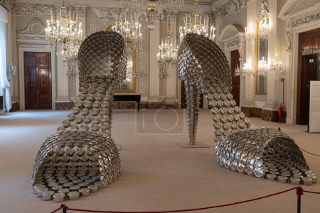 Photo for Florence,Italy-10-20-2023: Art exhibition of foot wear made from cooking steel pots utensils in Pitti palace Uffizi gallery selective focus background blur noise - Royalty Free Image