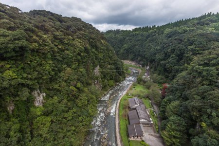 Photo for Green valley and japanese house in Kamikawa Otaki Waterfall Park, Kagoshima, Kyushu, Japan - Royalty Free Image