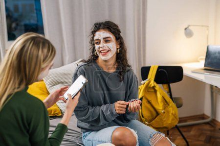 Photo for Two girls hang out with face masks on their face - Royalty Free Image