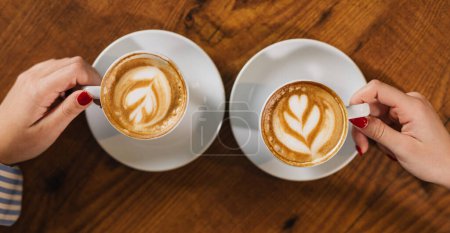 Photo for Close up view of hands holding cups of coffee - Royalty Free Image