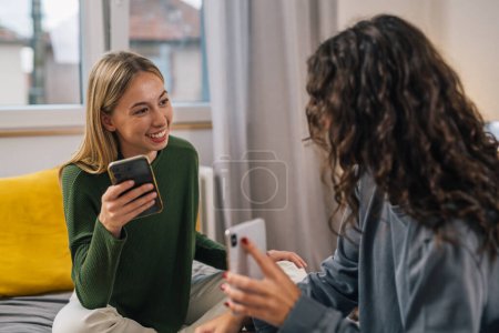 Photo for Two good friends talk together in bedroom - Royalty Free Image