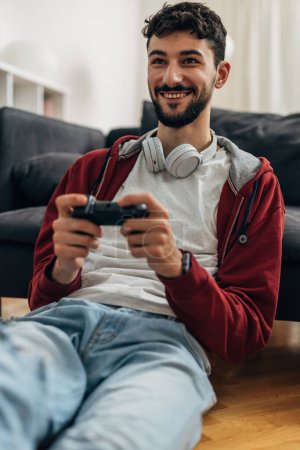 Photo for Happy young caucasian man plays video games - Royalty Free Image