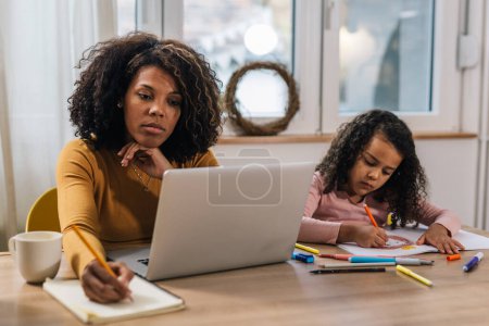 Photo for Mother doing household finances with her daughter - Royalty Free Image