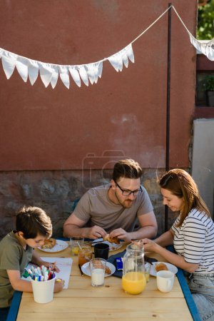 Photo for Family is having breakfast together outside the house - Royalty Free Image