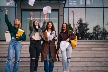 Four college friends are throwing away their notes after a successful exam