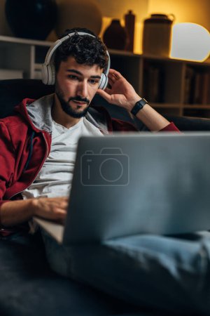 Photo for Young businessman attends a conference call from home - Royalty Free Image