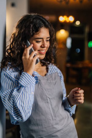 Photo for Waitress is talking on the phone - Royalty Free Image