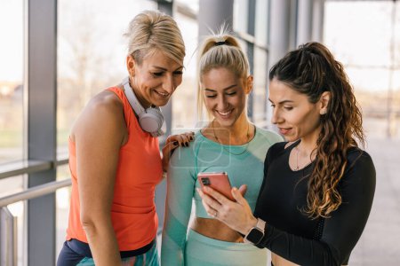 Photo for Three woman are talking in the gym - Royalty Free Image