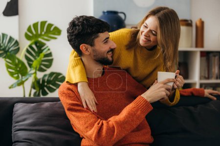 Photo for Affectionate girlfriend brings coffee to her boyfriend - Royalty Free Image