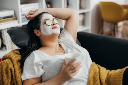 Photo for Woman waits for a face mask to process - Royalty Free Image