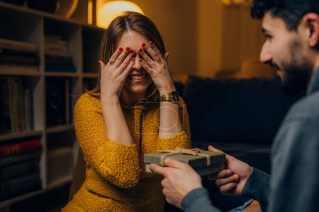 Photo for Woman covers her eyes before receiving a present from her boyfriend - Royalty Free Image