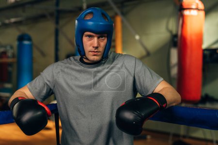 Photo for A serious man fighter is standing in the corner of the ring - Royalty Free Image