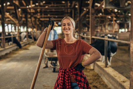 Photo for Portrait of a countrywoman working in a barn. - Royalty Free Image