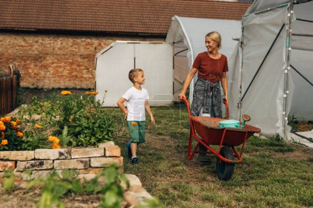 Téléchargez les photos : Mère et fils jardinage ensemble. - en image libre de droit