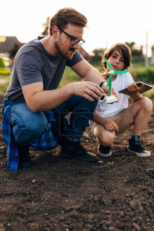 Photo for Father and son spend time together practical learning about wind energy - Royalty Free Image