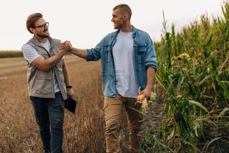 Photo for Two men greeting each other in the field. - Royalty Free Image