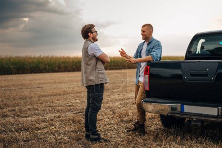 Photo for Two countrymen talking in the field. - Royalty Free Image
