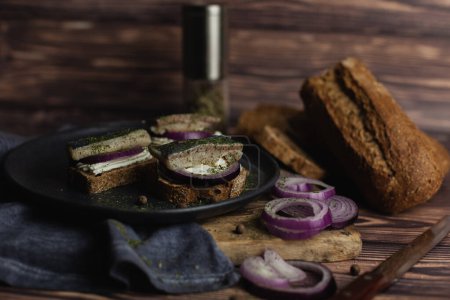 Photo for Canapes with herring, red onion and fresh bread - Royalty Free Image